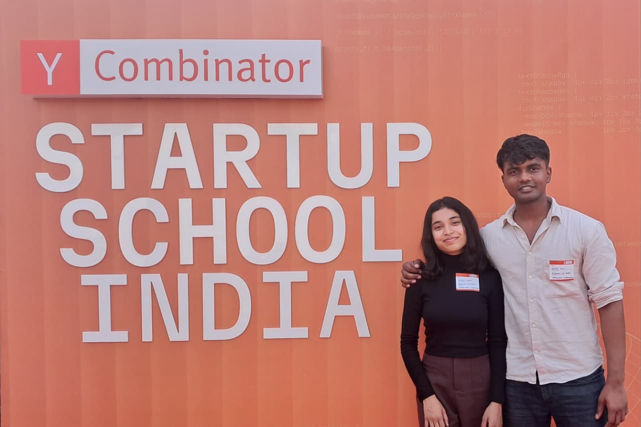 Saurabh and I at the YC Startup School India banner
